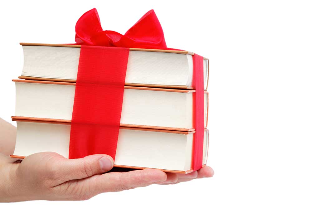 Stack of books wrapped with a ribbon, representing what you get when you have a ghostwriter write your book for you.